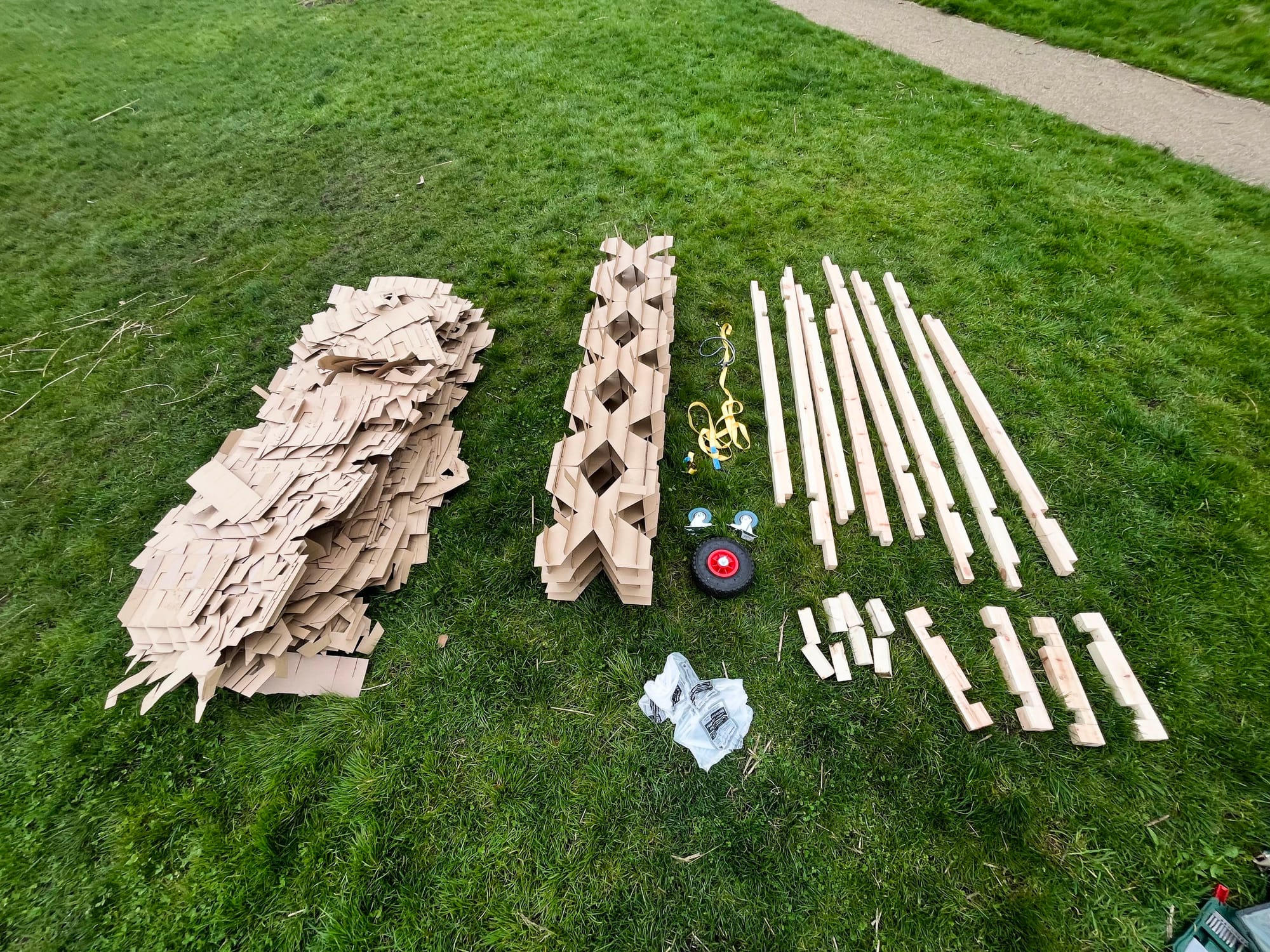 Photograph: flat pack of the cube structure from above, ready for cardboard recycling and part re-use.