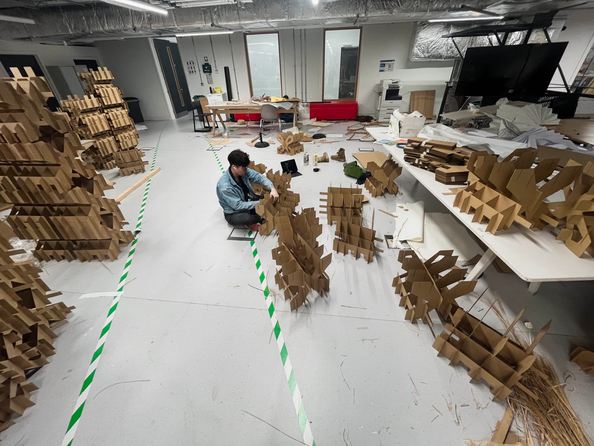 Second photograph of Ivan at work at cube assembly. 