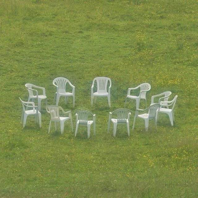 Ring of generic plastic chairs via Pinterest, unable to find artist.