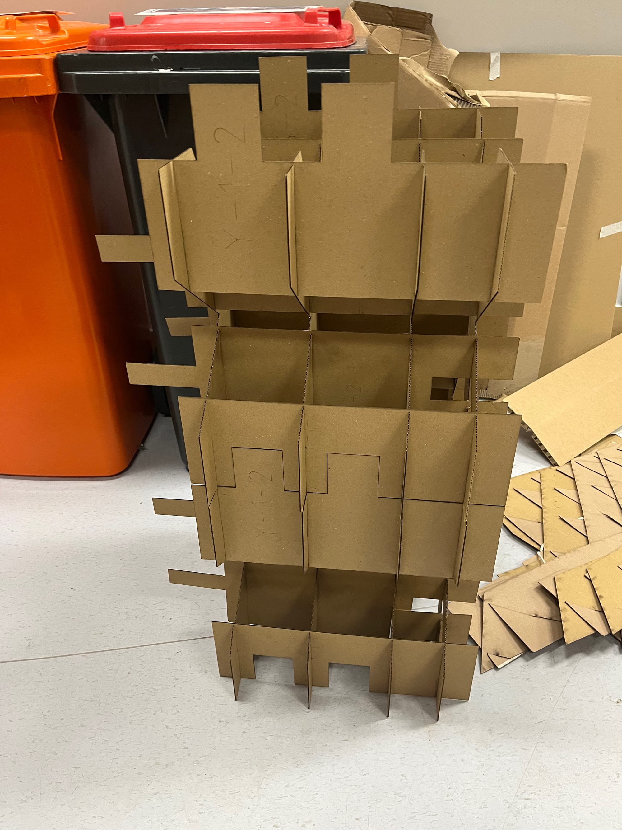 Photograph of two cardboard cubes interlocking vertically.