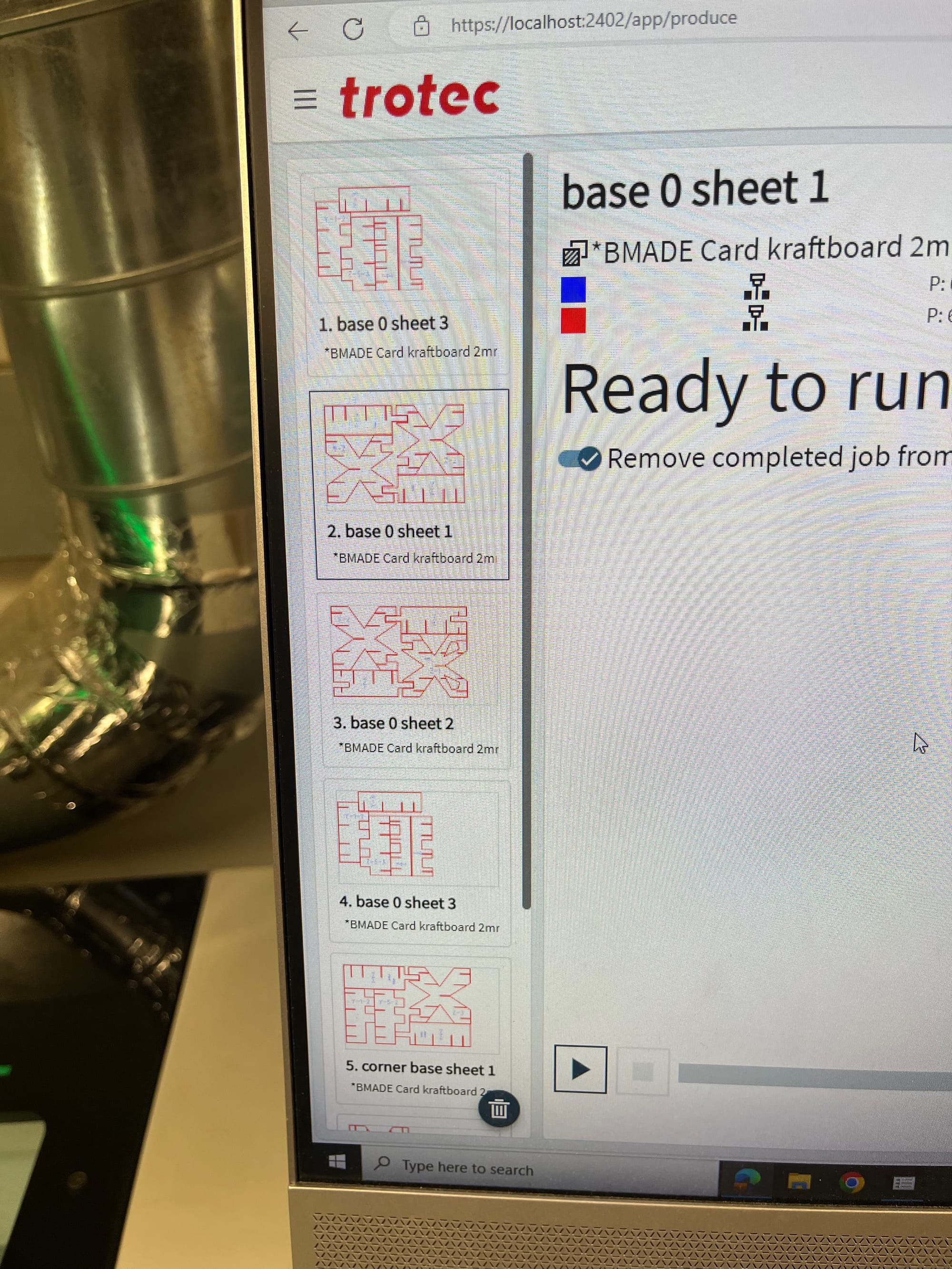 Photograph showing Trotec Ruby laser cutting interface with cube piece cut-jobs in progress.